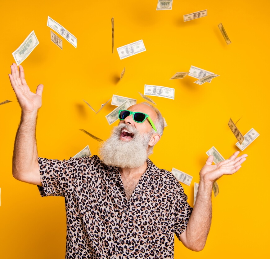 Funky old man enjoying a money rain (istock/deagreez)